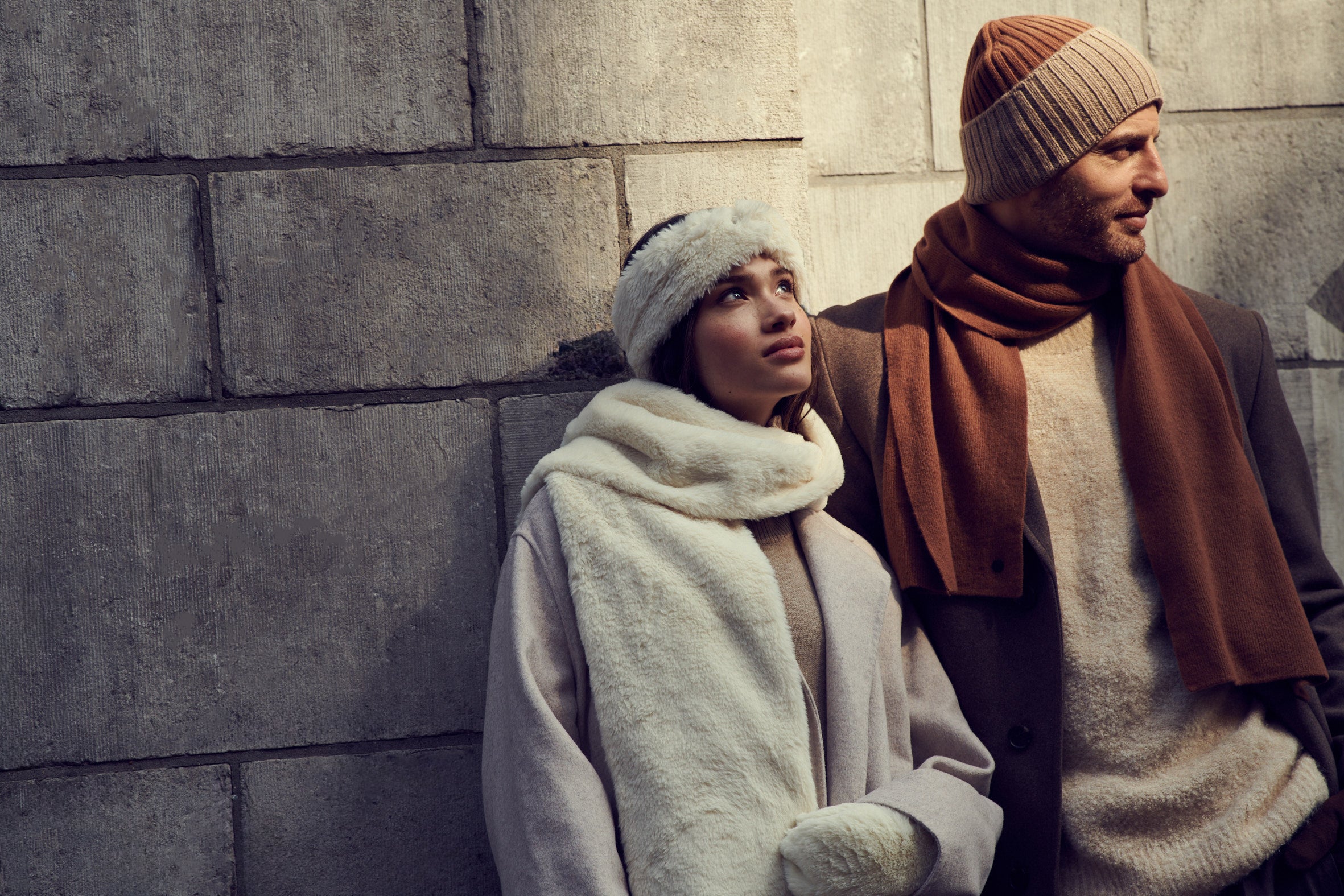 Couple with beanie and scarf standing in sun